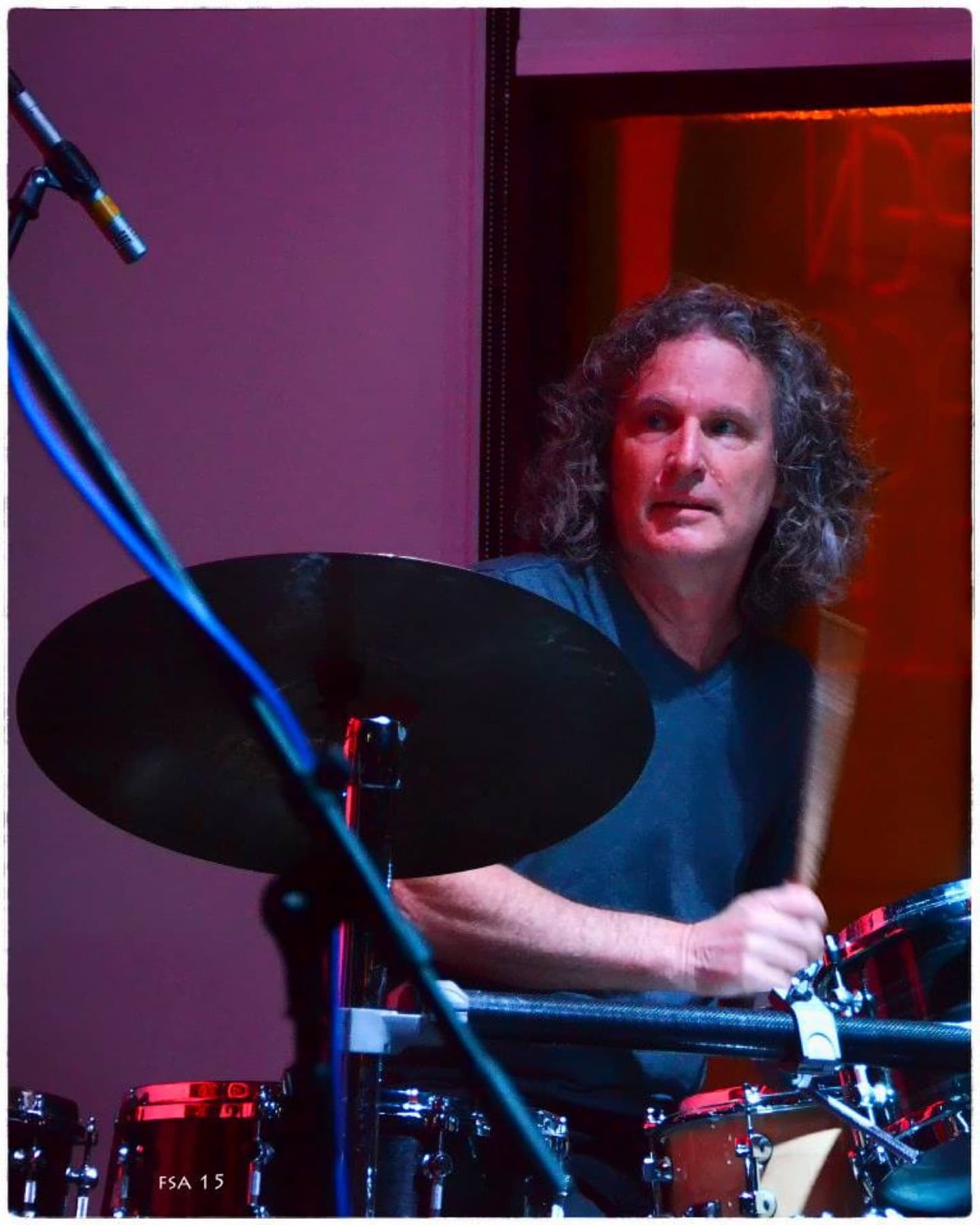 Steve Rucker drumming under stage lights