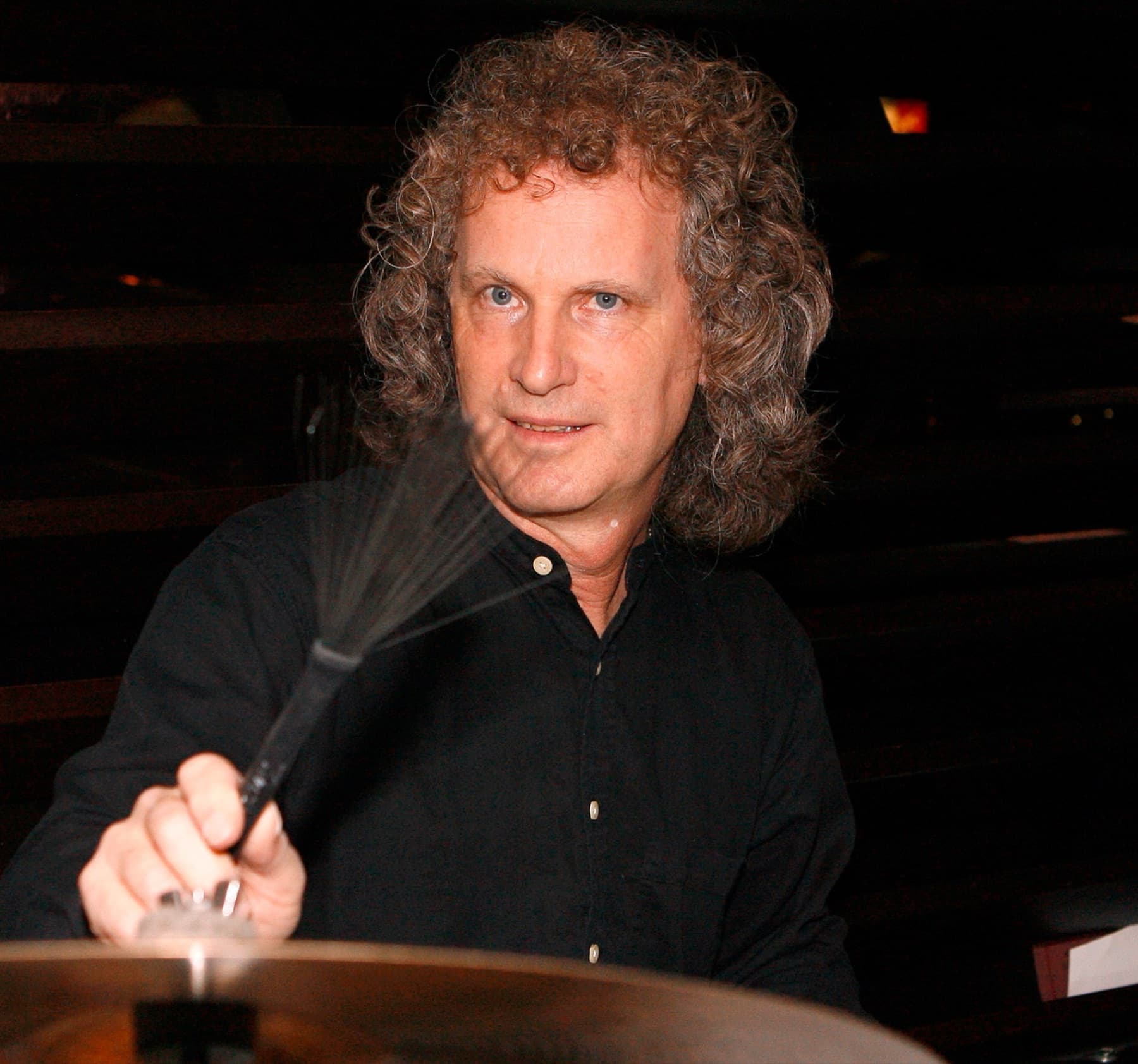 Steve Rucker holding a pair of brushes