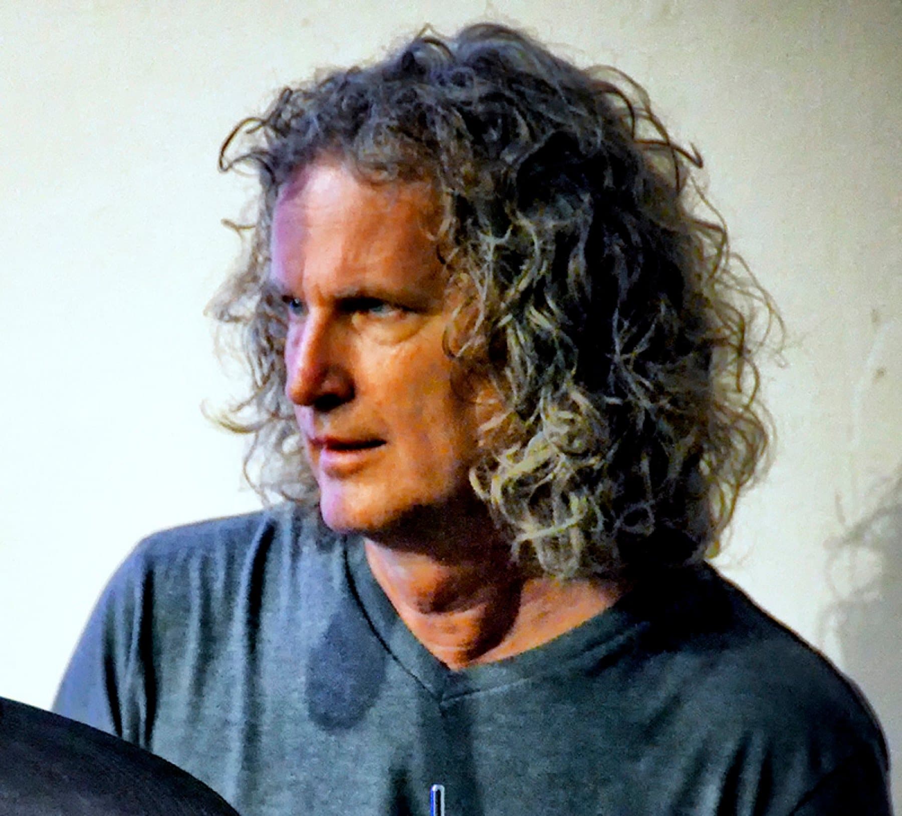 Portrait of Steve Rucker seated behind a cymbal